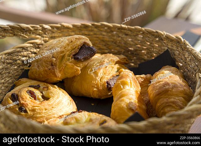 Pain au raisin and croissants in a basket