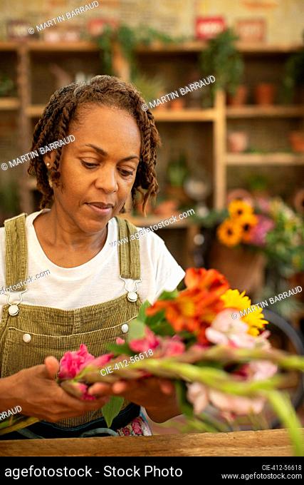 Female florist arranging flowers in shop