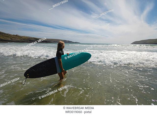 Female surfer standing in sea