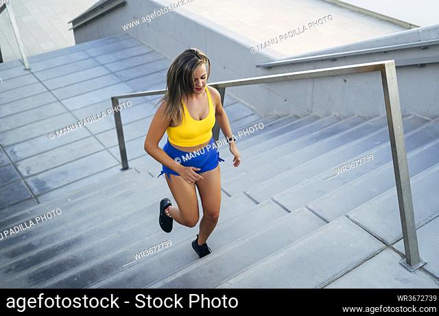 Young woman jogging on stairs