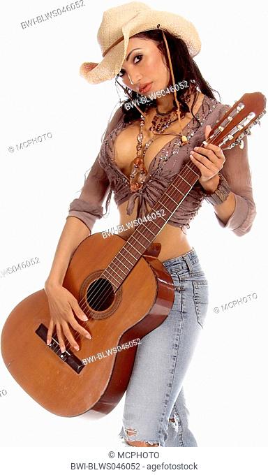young, dark haired woman in torn jeans and cowboyhat with a guitar