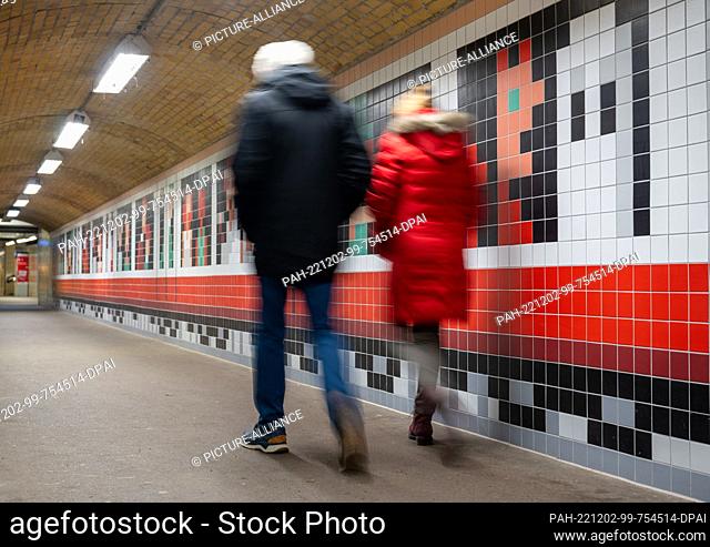 02 December 2022, Berlin: Passers-by walk through the pedestrian tunnel at Wannsee station, newly designed by illustrator Christoph Niemann