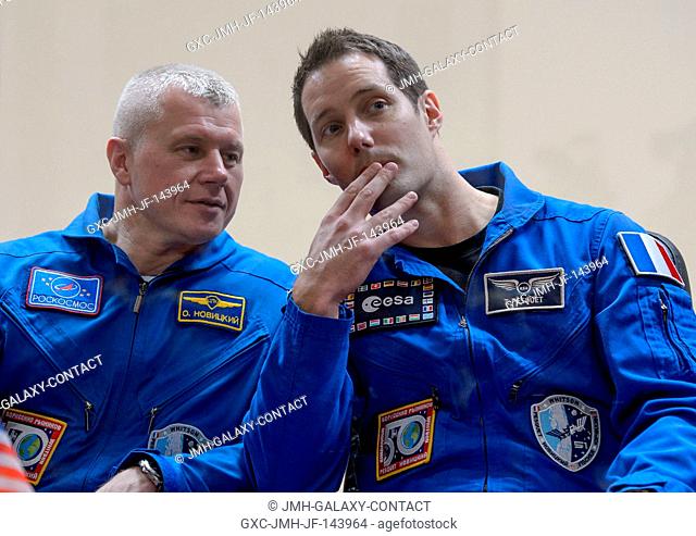 Expedition 50 Russian cosmonaut Oleg Novitskiy of Roscosmos, left, and ESA astronaut Thomas Pesquet are seen in quarantine behind glass during a crew press...