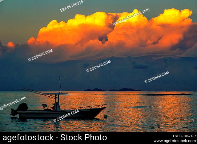 Silhouette of fishing boat at sunset on Taveuni Island, Fiji. Taveuni is the third largest island in Fiji