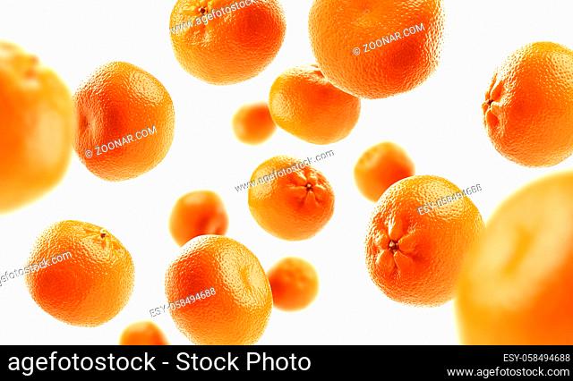 Whole oranges levitate on a white background