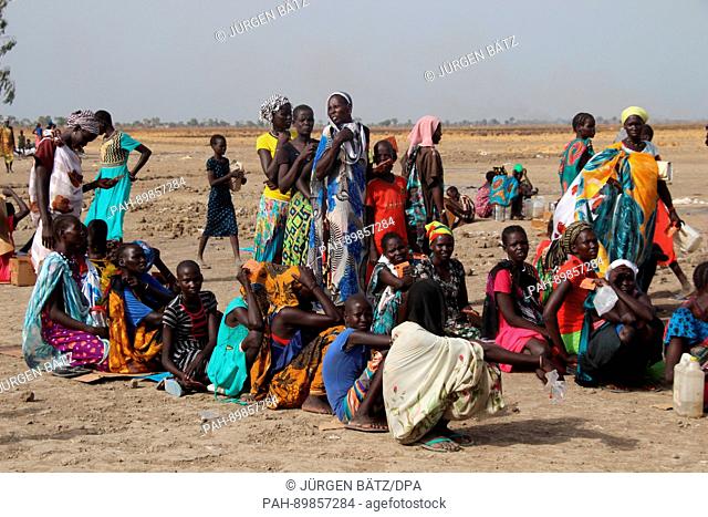 Women waiting in line to receive their monthly food aid ration by the Welthungerhilfe (lit. World Hunger Aid) in Ganyliel, South Sudan, 24 March 2017