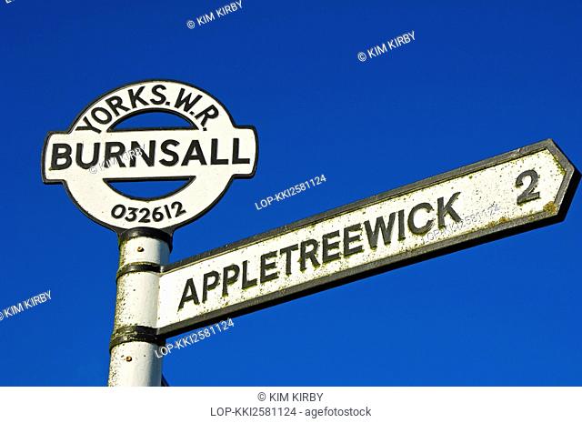 England, North Yorkshire, Burnsall. Road sign at Burnsall showing direction and mileage to Appletreewick