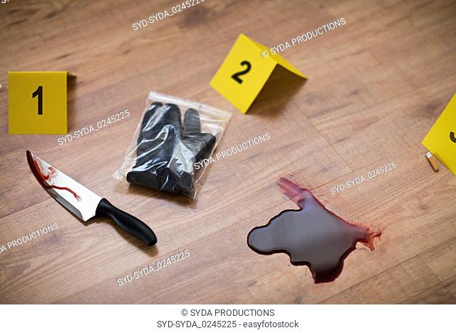 knife in blood and evidence marker at crime scene