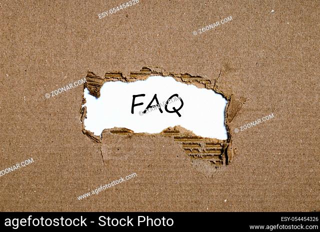 The word faq appearing behind torn paper