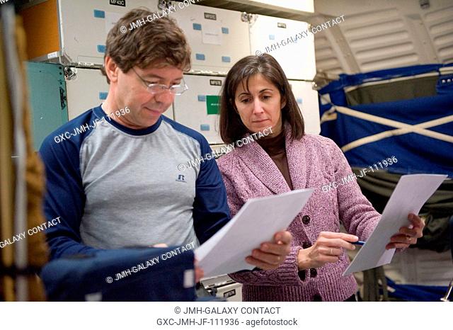 NASA astronauts Michael Barratt and Nicole Stott, both STS-133 mission specialists, participate in training session in a shuttle mock-up in the Space Vehicle...