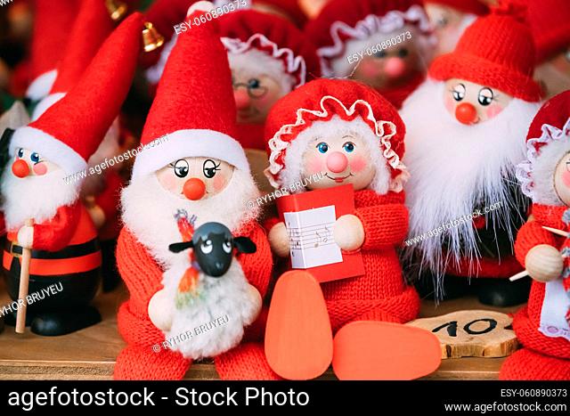 Traditional Souvenirs Santa Claus Dolls Toys At European Winter Christmas Market. New Year Wooden Souvenir From Europe