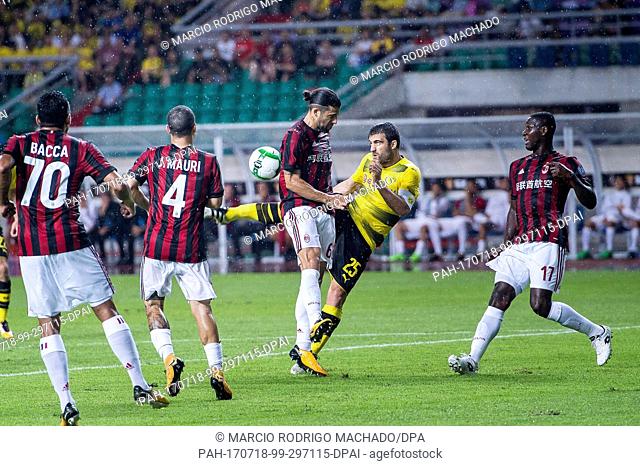Borussia Dortmund Defender Sokratis Papastathopoulos (C) attempts a kick while being AC Milan Midfielder Ricardo Rodriguez (C) defended by during the...