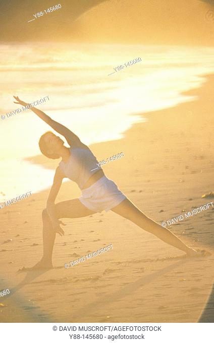 Woman stretching on the beach