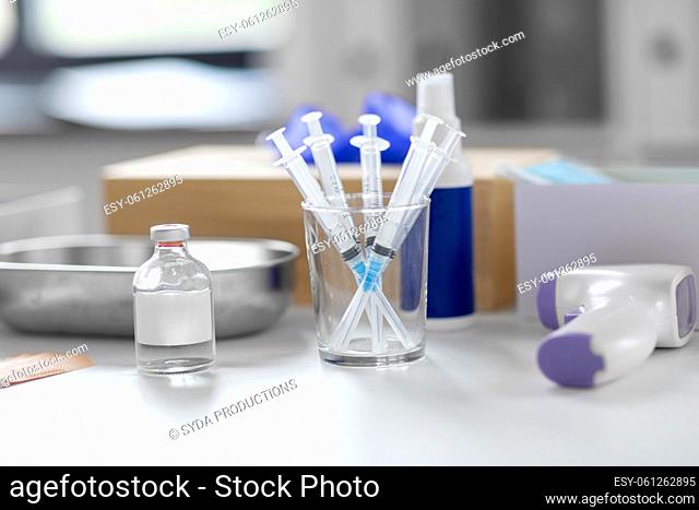 syringes, medicine and other stuff on table