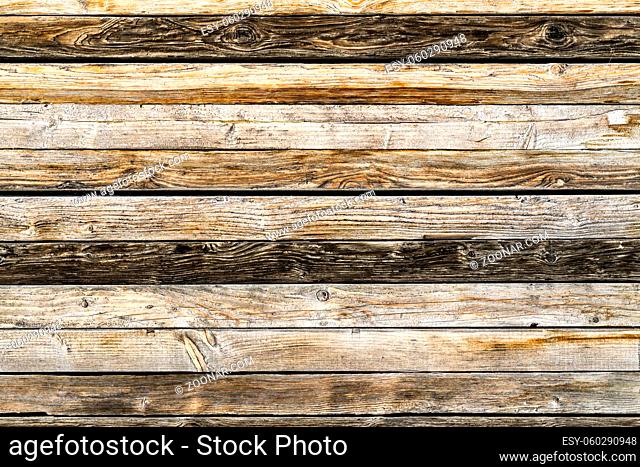 Old weathered brown barn wood wall. Wooden wall background design. Wood planks, boards are old with a beautiful rustic look