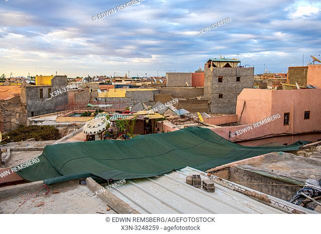 View from terrace overlooking the collection of buildings nestled close together in medina quarter of Marrakesh, Morocco