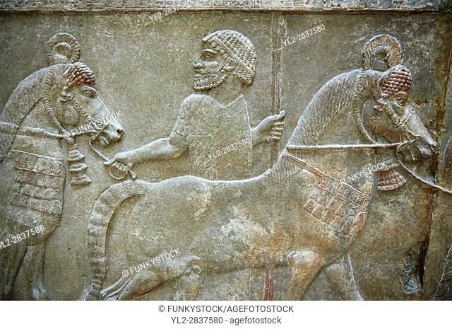 Stone relief sculptured panel of horses and soldiers from corridor 10. Facade L. Inv AO 19918 from Dur Sharrukin the palace of Assyrian king Sargon II at...
