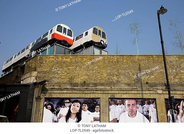 England, London, Shoreditch, Looking up to two tube carriages being used as offices on the top of a building in East London