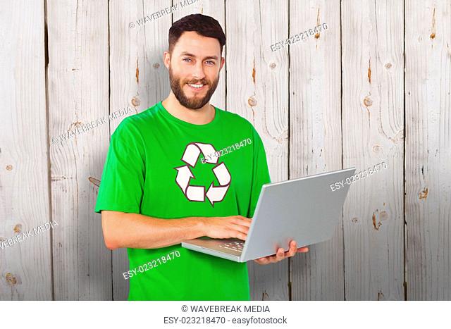 Composite image of portrait of man working on laptop in office