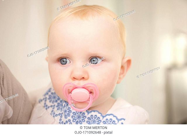 Close up of baby with pink pacifier