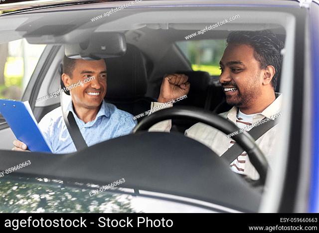 smiling car driving school instructor and driver