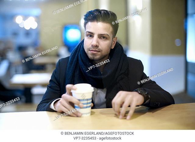 young man with takeaway coffee, in Munich, Germany