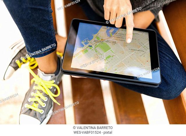 Close-up of woman using tablet with digital street map