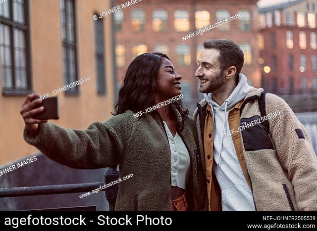 Happy couple taking selfie