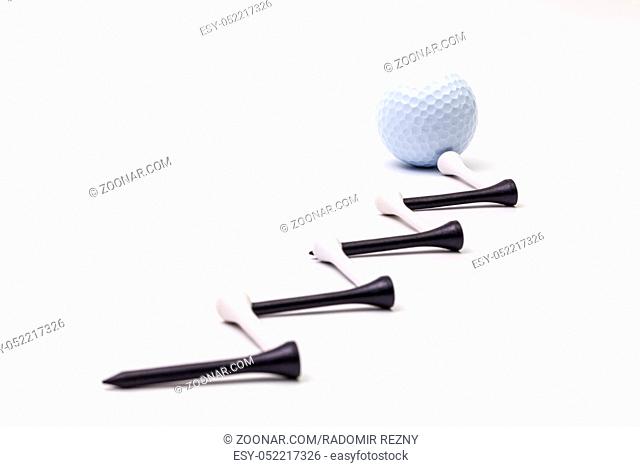 White golf balls and wooden tees on the white background.Golf concept
