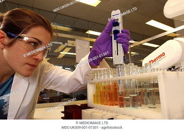 A medicinal chemist prepares a set of test tubes containing organic compounds for further analysis in a drug discovery and development project