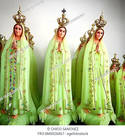 Green sculptures of Our Lady of the Rosary for sale in a shop in Fatima, Portugal