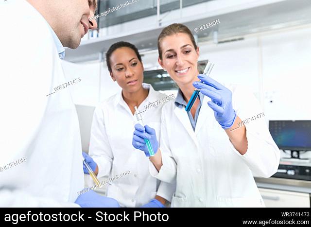 Team of researchers doing experiment in science lab