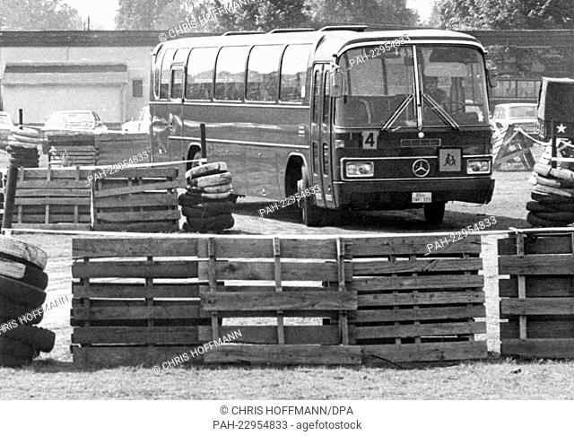 A bus drives through a reproduction of the Checkpoint Charlie in the Andrew Barracks in Berlin on the 24th of May in 1977
