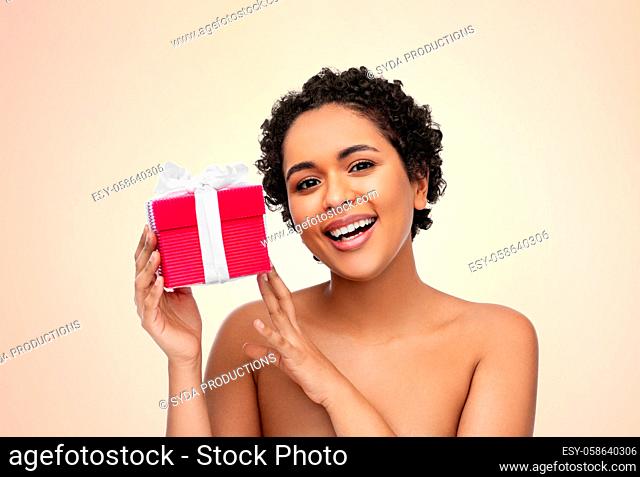 portrait of young african american woman with gift