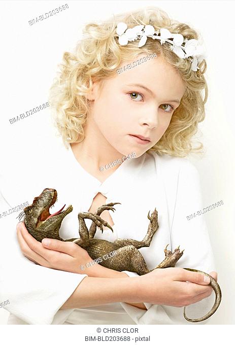 Girl cradling baby dinosaur