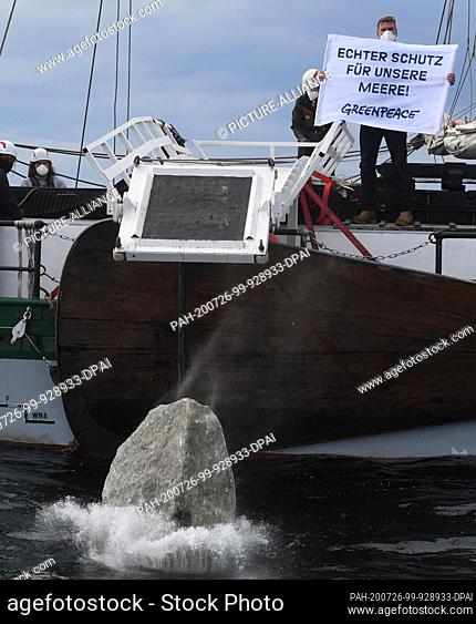 26 July 2020, Mecklenburg-Western Pomerania, Sassnitz: Greenpeace activists sink large granite blocks into the sea from the Greenpeace ship ""Beluga II"" off...