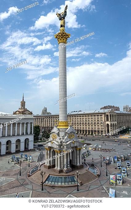 Independence Monument with Berehynia statue on Maidan Nezalezhnosti square in Kiev, Ukraine. Centra Post Office on background
