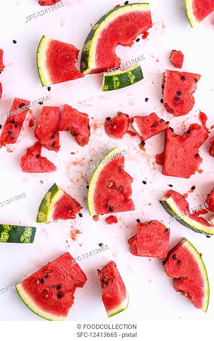 Watermelon pieces, some with bites taken out (seen from above)
