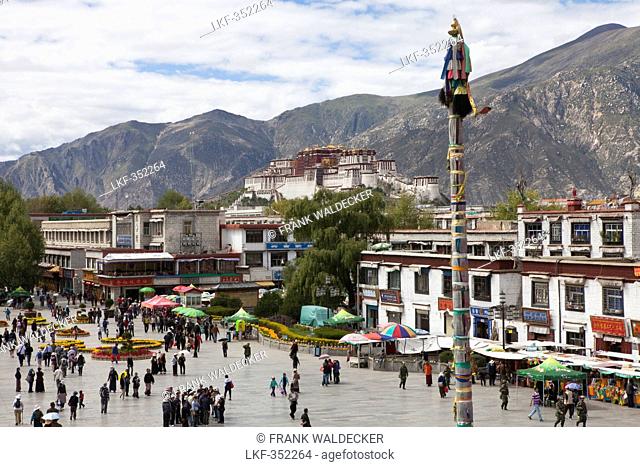 Pilgrims at Barkhor Square in the old part of Lhasa with Potala, Tibet Autonomous Region, People's Republic of China