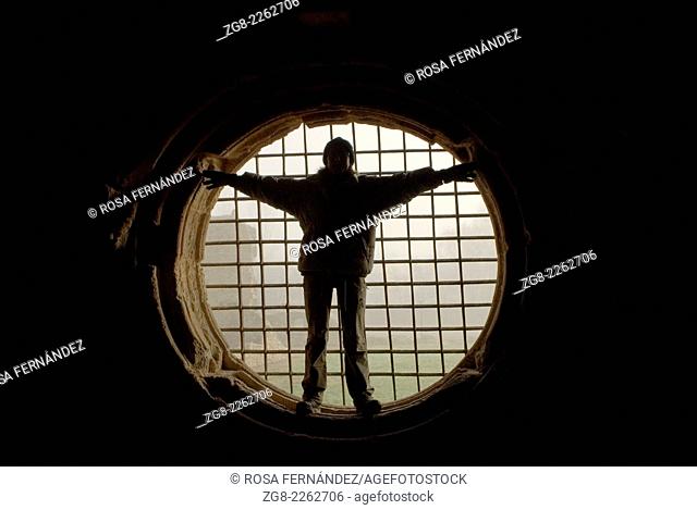 Human silouette fitted in a big circular window with iron bars, Monastery of Santa Maria de Carracedo, Carracedelo, province of León, Castilla y León, Spain