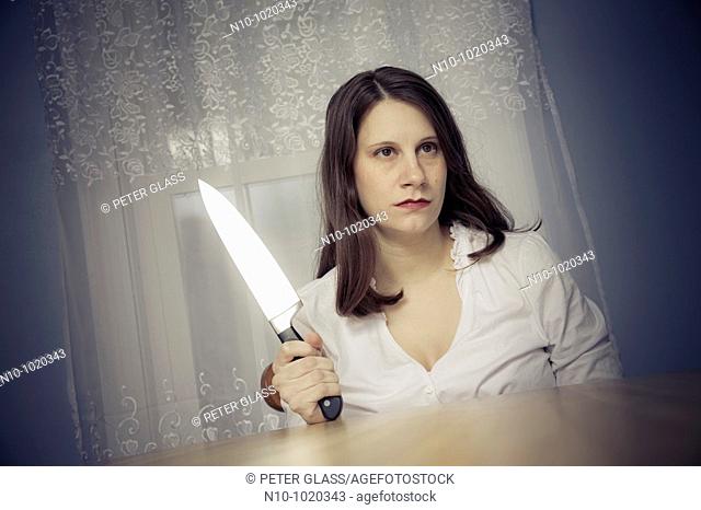 Young woman holding a large knife
