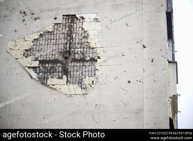 20 October 2023, Ukraine, Irpin: A partially repaired bullet hole can be seen on the side of a multi-story house. The town near Kiev was partially destroyed by...