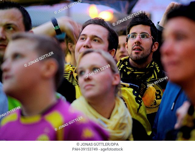 Fans of the German Bundesliga soccer club Borussia Dortmund look at a screen during a public viewing of the Champions League semi-final match between Borussia...