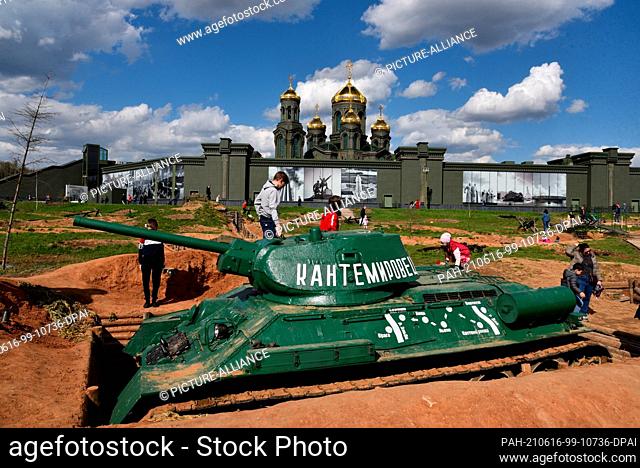 07 May 2021, Russia, Moskau: Children play on a Russian T34 tank in a position. The scene is part of the ""Patriot Park"" built from scratch by the Ministry of...