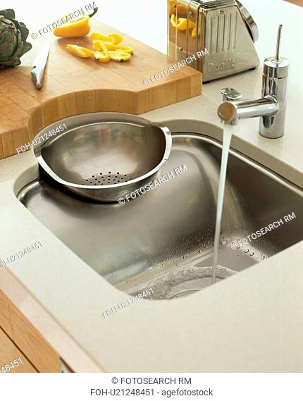Close-up of Philippe Starck stainless steel sink and drainer with Franke tap
