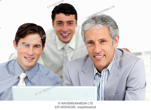 Self-assured business partners working at a computer in an office