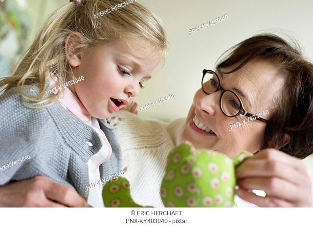 Close-up of a girl playing with her grandmother