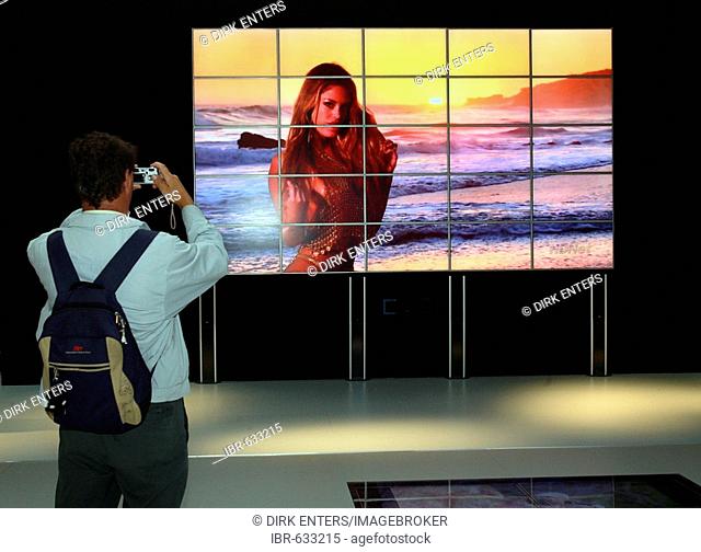 Customer takes a picture of his pixel dream girl - IFA 2007 (Consumer Electronics Unlimited) in Berlin, Germany, Europe
