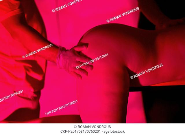 One of 13 naked woman exhibits herself during the three-day exhibition named Voayer, which shows 13 naked women mostly in submissive positions, in Prague