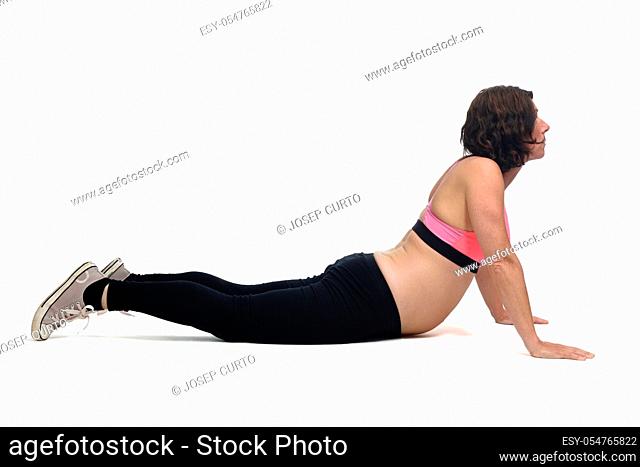 pregnant woman doing floor exercises on white background